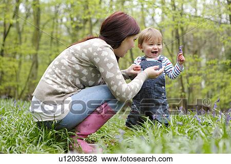 Mother and son playing in forest View Large Photo Image Stock Photo - Mother and son playing in forest. Fotosearch