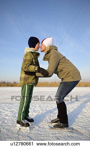 Mother and son touching noses on ice View Large Photo Image Stock Image - Mother and son touching noses on ice. Fotosearch