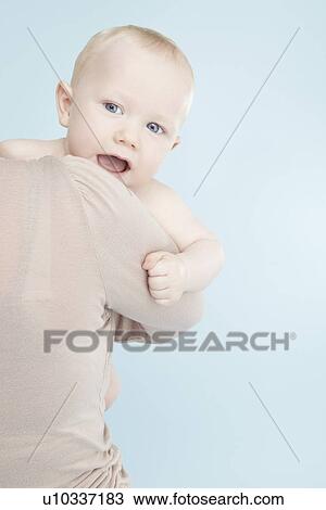 Mother carrying baby boy View Large Photo Image Stock Image - Mother carrying baby boy. Fotosearch