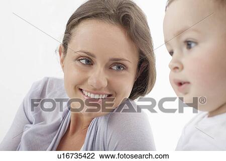 Stock Image - Mother smiling at baby. Fotosearch