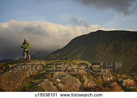 Mountain biker on rural road View Large Photo Image Stock Image - Mountain biker on rural road. Fotosearch