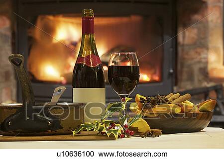 Stock Image - Mulled wine and spices at table. Fotosearch