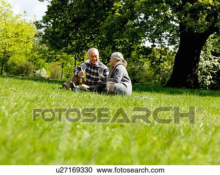 Older couple drinking wine at picnic View Large Photo Image Stock Image - Older couple drinking wine at picnic. Fotosearch
