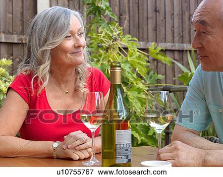 Older couple drinking wine together View Large Photo Image Stock Photo - Older couple drinking wine together. Fotosearch