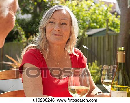Stock Photograph - Older couple drinking wine together. Fotosearch