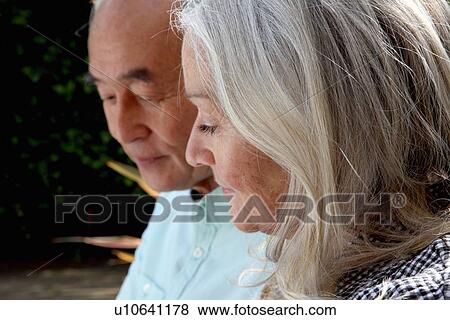 Older couple sitting outside together View Large Photo Image Stock Photo - Older couple sitting outside together. Fotosearch