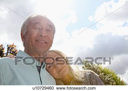Older couple standing outside together View Large Photo Image Stock Image - Older couple standing outside together. Fotosearch