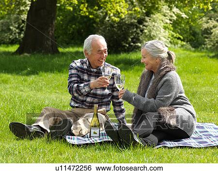 Stock Photograph - Older couple toasting each other. Fotosearch