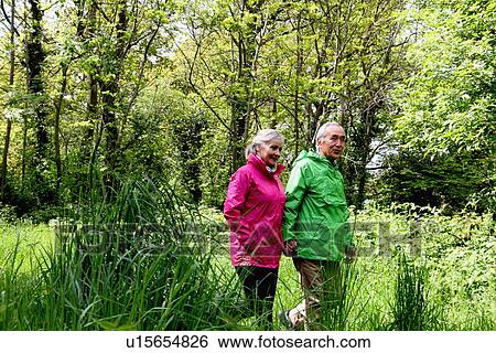 Older couple walking in forest View Large Photo Image Stock Photograph - Older couple walking in forest. Fotosearch