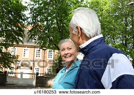 Older couple walking in park View Large Photo Image Stock Image - Older couple walking in park. Fotosearch