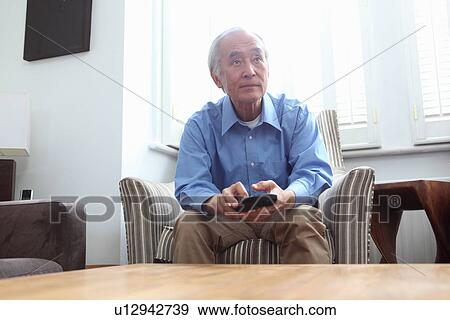 Older man watching television View Large Photo Image Stock Photo - Older man watching television. Fotosearch