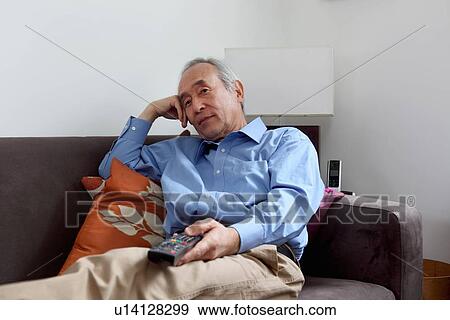 Older man watching television View Large Photo Image Stock Photo - Older man watching television. Fotosearch