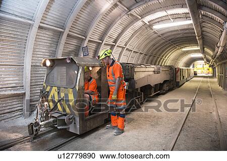 Stock Image - Operators working in coal mine. Fotosearch