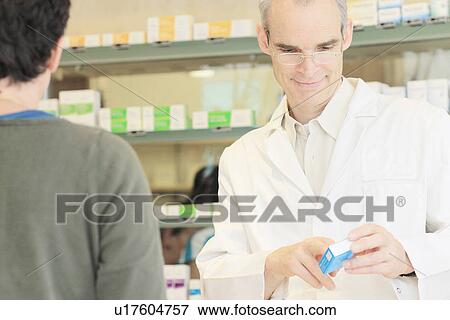 Pharmacist talking with customer View Large Photo Image Stock Photo - Pharmacist talking with customer. Fotosearch