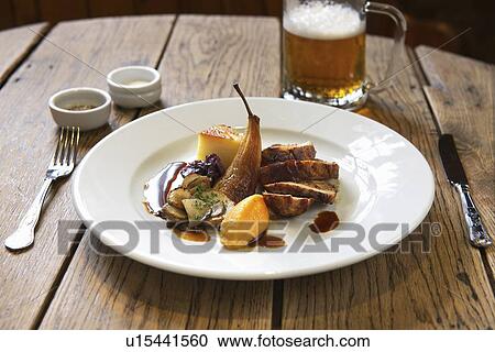 Plate of stuffed pork with pear View Large Photo Image Stock Image - Plate of stuffed pork with pear. Fotosearch