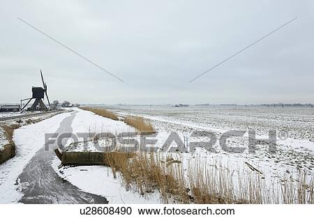 Stock Image - Rural road in snowy landscape. Fotosearch
