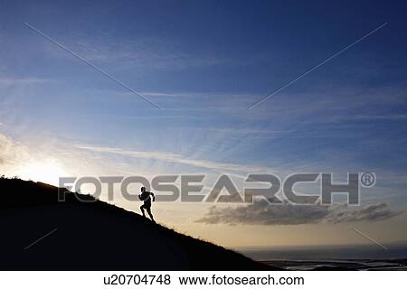 Silhouette of hiker running up hillside View Large Photo Image Stock Photo - Silhouette of hiker running up hillside. Fotosearch