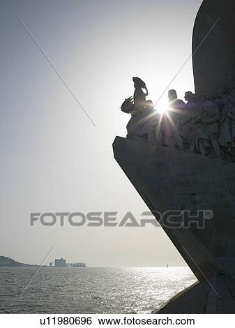 Stock Photograph - Silhouette of ornate statue by water. Fotosearch