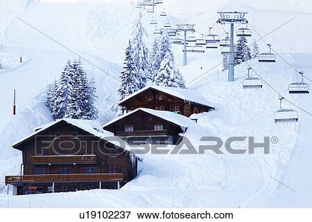Ski lifts over lodges in snow drift View Large Photo Image Stock Photo - Ski lifts over lodges in snow drift. Fotosearch