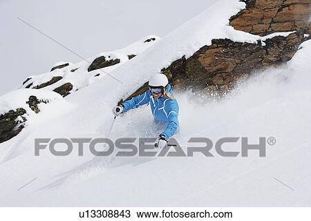 Skier coasting on snowy slope View Large Photo Image Stock Image - Skier coasting on snowy slope. Fotosearch