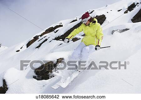 Skier coasting on snowy slope View Large Photo Image Stock Image - Skier coasting on snowy slope. Fotosearch