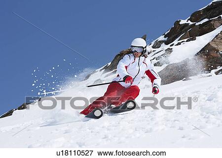 Skier coasting on snowy slope View Large Photo Image Stock Photo - Skier coasting on snowy slope. Fotosearch