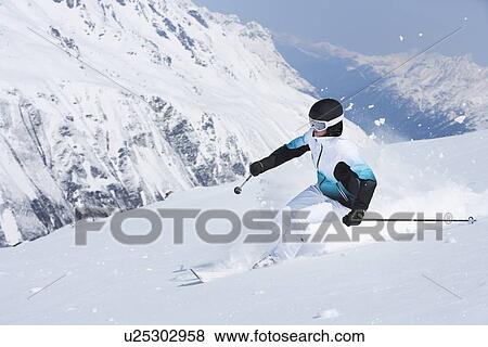 Skier coasting on snowy slope View Large Photo Image Stock Photo - Skier coasting on snowy slope. Fotosearch