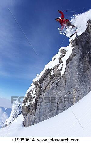 Skier jumping on rocky slope View Large Photo Image Picture - Skier jumping on rocky slope. Fotosearch