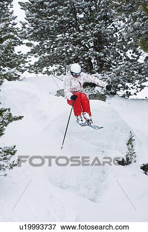Skier jumping on snowy slope View Large Photo Image Stock Photo - Skier jumping on snowy slope. Fotosearch