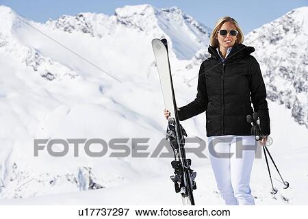 Skier standing on snowy mountain View Large Photo Image Stock Photo - Skier standing on snowy mountain. Fotosearch