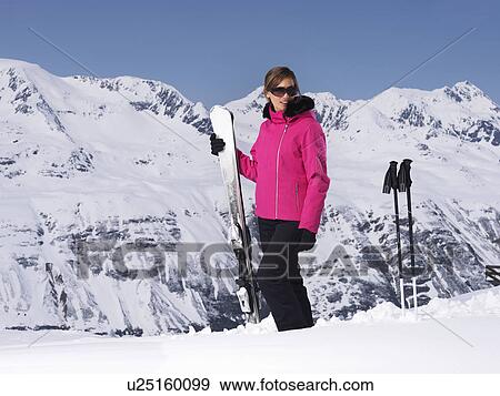 Stock Photo - Skier standing on snowy mountain. Fotosearch