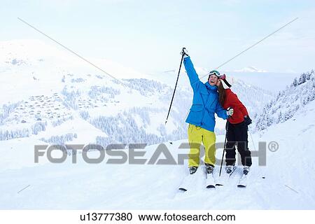 Skiers celebrating on snowy mountaintop View Large Photo Image Stock Image - Skiers celebrating on snowy mountaintop. Fotosearch