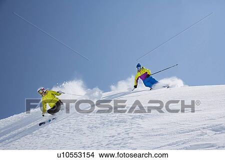 Skiers coasting on snowy slope View Large Photo Image Picture - Skiers coasting on snowy slope. Fotosearch