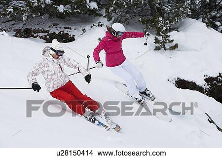 Skiers coasting on snowy slope View Large Photo Image Picture - Skiers coasting on snowy slope. Fotosearch