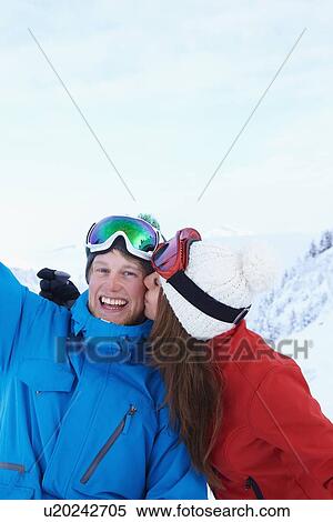 Stock Photography - Skiers kissing in snow. Fotosearch