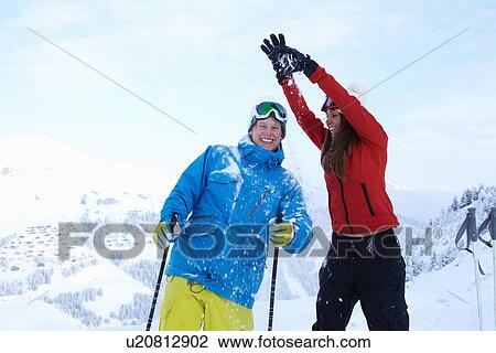 Skiers playing on snowy mountaintop View Large Photo Image Stock Image - Skiers playing on snowy mountaintop. Fotosearch