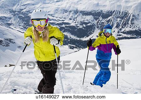 Stock Photo - Skiers standing on snowy slope. Fotosearch