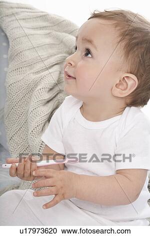 Smiling baby playing with plastic spoon View Large Photo Image Stock Image - Smiling baby playing with plastic spoon. Fotosearch