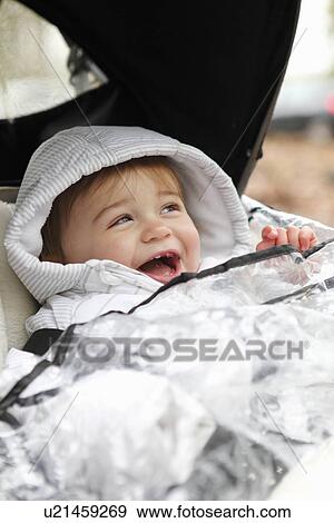 Smiling boy riding in stroller outdoors View Large Photo Image Stock Photo - Smiling boy riding in stroller outdoors. Fotosearch