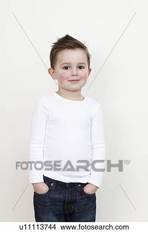 Picture - Smiling boy with hands in pockets. Fotosearch