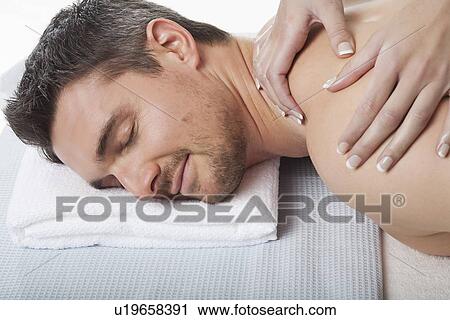 Smiling man having back massage View Large Photo Image Stock Image - Smiling man having back massage. Fotosearch