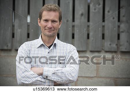Smiling man standing outside View Large Photo Image Stock Image - Smiling man standing outside. Fotosearch