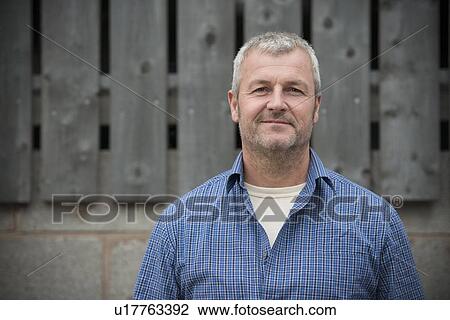 Smiling man standing outside View Large Photo Image Stock Image - Smiling man standing outside. Fotosearch