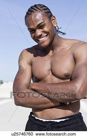 Smiling man standing with arms crossed View Large Photo Image Stock Image - Smiling man standing with arms crossed. Fotosearch