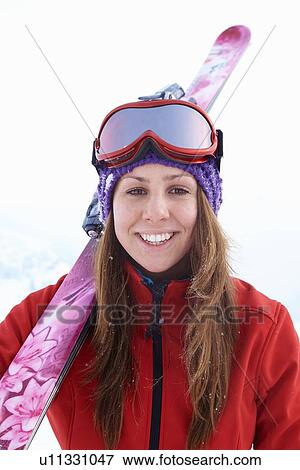 Smiling skier carrying skis View Large Photo Image Stock Photo - Smiling skier carrying skis. Fotosearch
