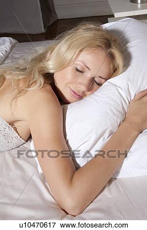 Smiling woman asleep in bed View Large Photo Image Stock Photo - Smiling woman asleep in bed. Fotosearch