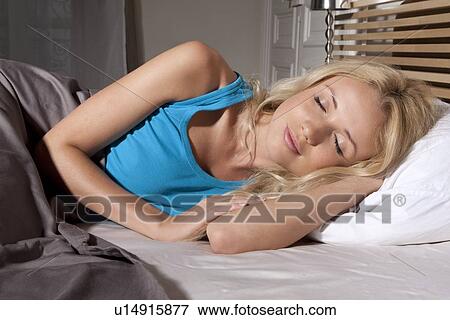 Smiling woman asleep in bed View Large Photo Image Stock Photo - Smiling woman asleep in bed. Fotosearch