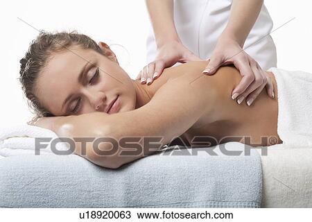 Smiling woman having back massage View Large Photo Image Stock Image - Smiling woman having back massage. Fotosearch