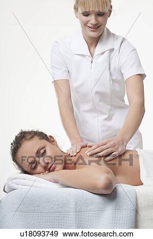 Smiling woman having back massage View Large Photo Image Stock Photo - Smiling woman having back massage. Fotosearch