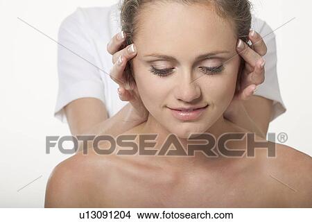 Picture - Smiling woman having scalp massage. Fotosearch